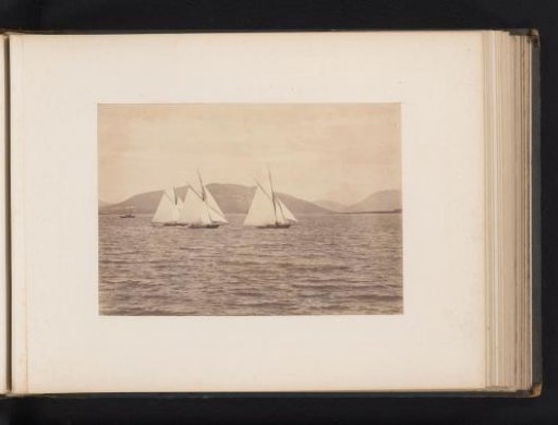 Sailing ships Maida, Yvonne and Encore afloat with a hilly landscape in the background