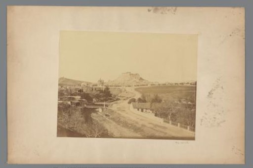 View of the Acropolis with a country road and a temple ruin in the foreground