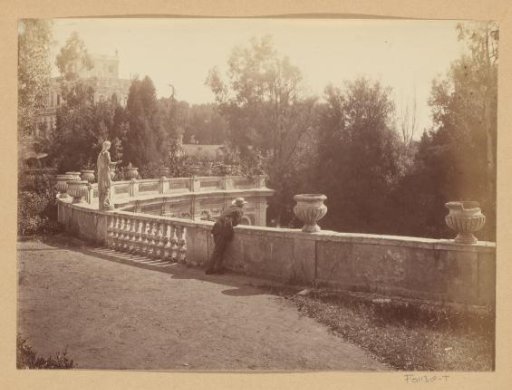 Man leaning on a balustrade, probably in a park in Italy