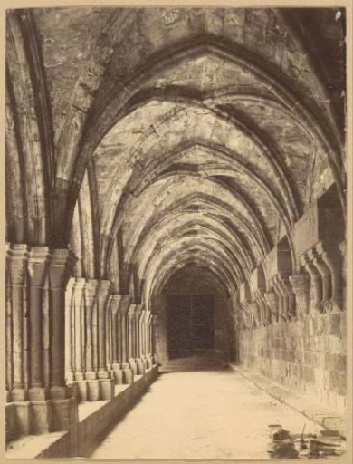 Cloister walk in the Monastery of Poblet near Vimbodí in the municipality of Tarragona, with some writing materials in the foreground