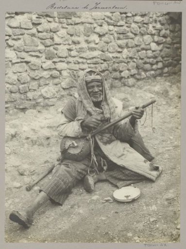 Seated Beggar with Stringed Instrument in Jerusalem