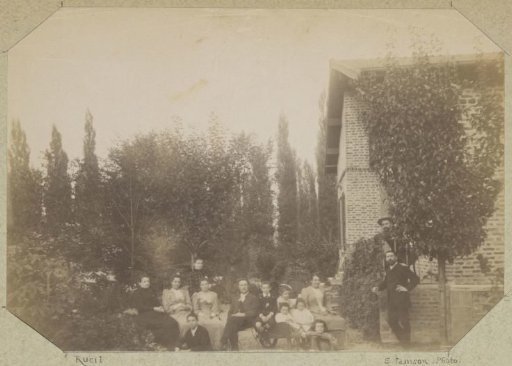 Group portrait of a French family in a garden in Rueil