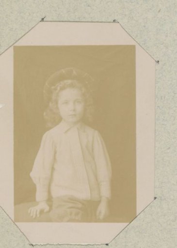 Portrait of a young child wearing a cap, probably in France