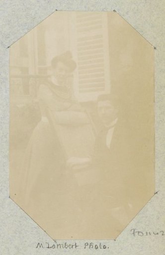 Portrait of a man and a woman by a window with shutters, probably in France