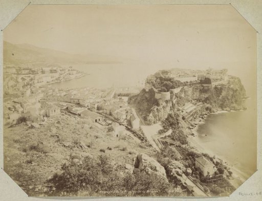 View of Monaco with the old fortified city on the right and a railway station in the foreground