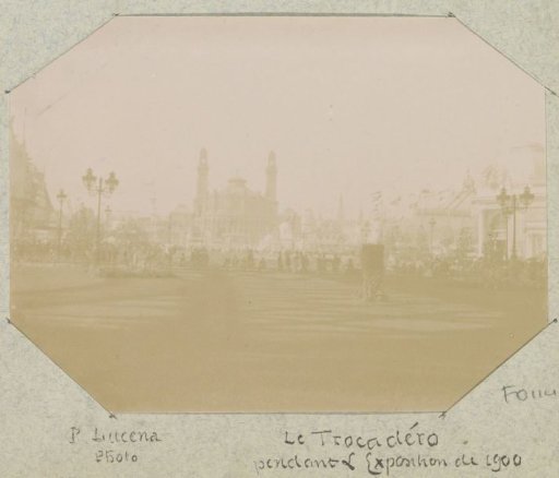 View of the Palais du Trocadéro during the 1900 World's Fair in Paris, with the shadow of the Eiffel Tower in the foreground