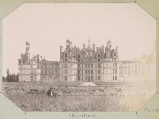 Château of Chambord with a man in a meadow in the foreground