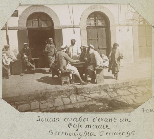 Men playing a board game in front of a café in Berrouaghia (Algeria)