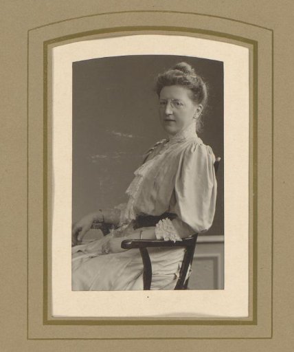 Portrait of a woman with glasses on a chair