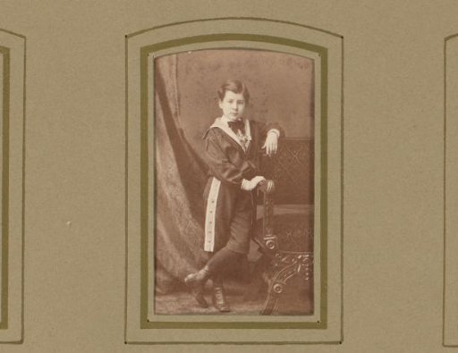 Portrait of a boy leaning on a chair