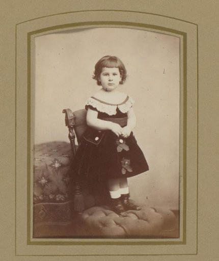 Portrait of a girl standing on a chair