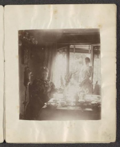 Two women in a living room with an open door