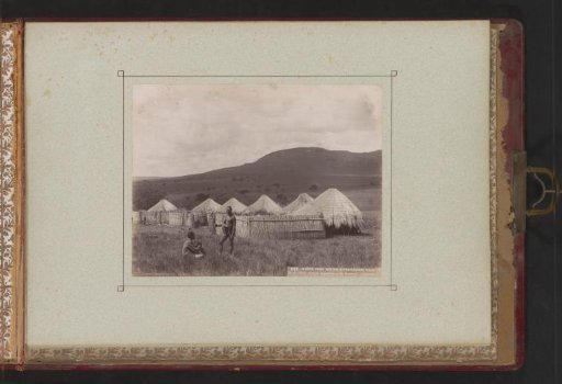 Two Xhosa people in front of their dwellings at the foot of the Witwatersrand hills