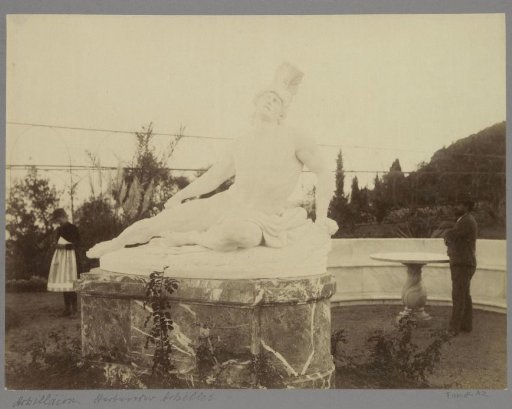 Statue of Achilles at the Achilleion on Corfu with visitors on either side
