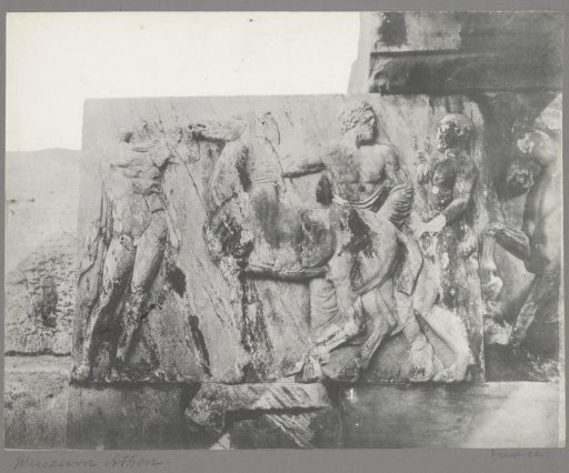 Relief of men with a horse in a museum in Athens
