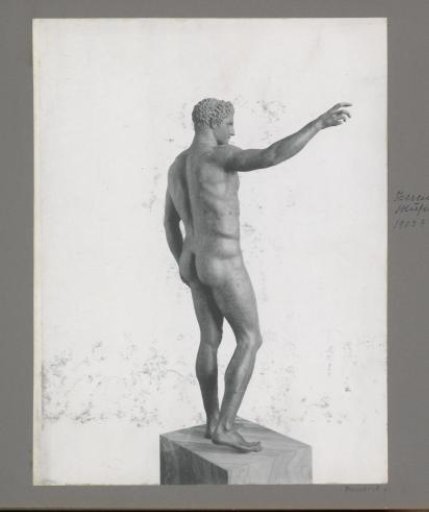 Antique bronze statue of a young man (rear view), presumably in a museum in Athens