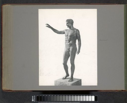 Antique bronze statue of a young man (front view), presumably in a museum in Athens