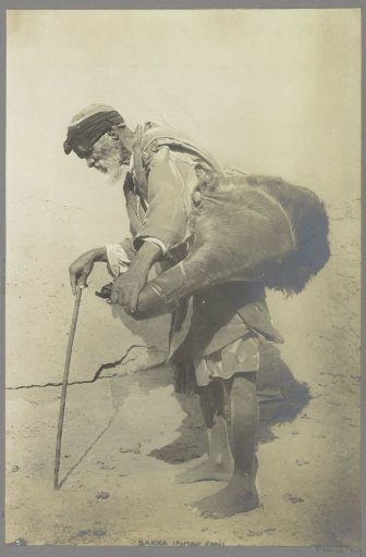 Portrait of a water carrier in Saqqara, barefoot with staff