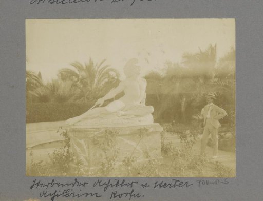 Man standing next to the statue of Achilles at the Achilleion on Corfu