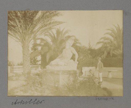Man standing next to the statue of Achilles at the Achilleion on Corfu