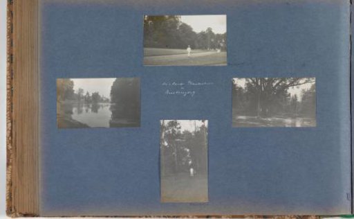 Two Europeans posing in front of a tree by a pond in the State Botanical Garden at Buitenzorg