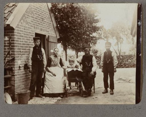 Family portrait of a man and woman and three children in traditional dress
