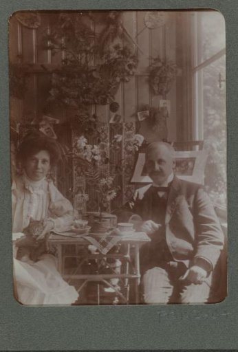 Portrait of a man and woman, sitting in a conservatory