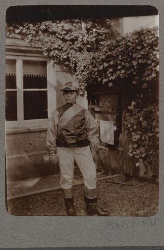 Portrait of a boy in an elaborate costume, standing in a garden