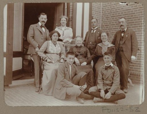 Group portrait of a party in front of French doors leading to the garden