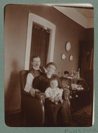 Portrait of a man and a woman with a baby on their lap