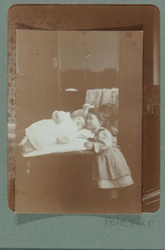 Portrait of a little girl admiring a baby