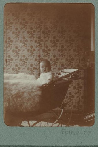 Baby seated in a pram