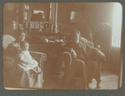 Portrait of a man, a woman, and a child in an interior