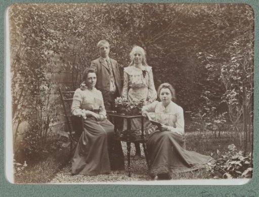 Group portrait of two women and two children in a garden