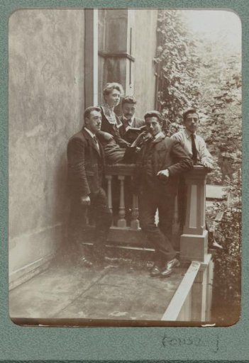 Group portrait of four men and a woman standing on a flat roof with Christiaan Otto Roelofs on the left