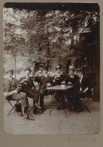 Group portrait of beer-drinking men on a terrace