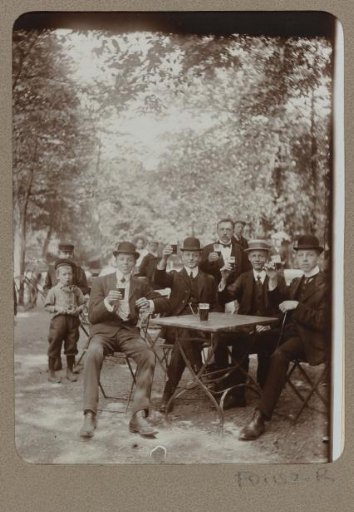 Group portrait of beer-drinking men on a terrace