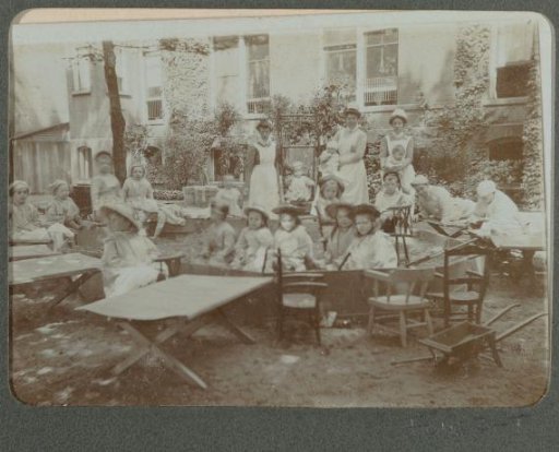 Group of children and nurses outside a hospital