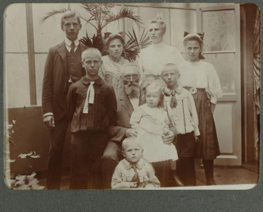 Family portrait of children in a greenhouse