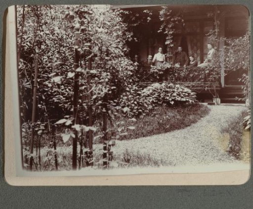 Family on the veranda in front of a house