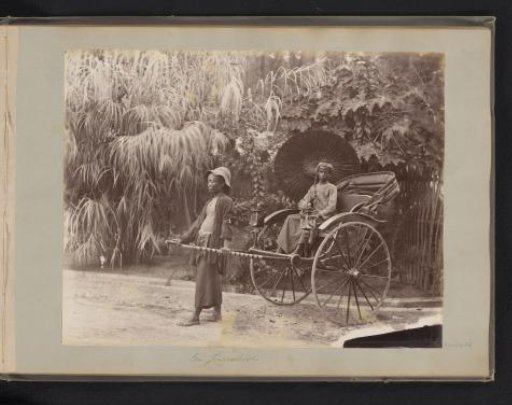 Young man in a rickshaw and man in front of the rickshaw