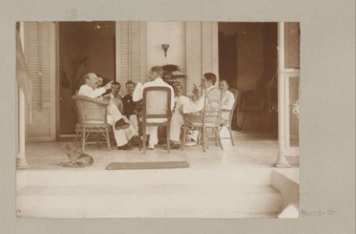 European men at a table on a veranda