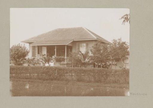 Soldier with family in front of a house