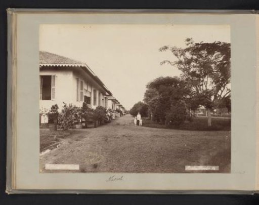 Woman with children on the grass near villas at Kota-Radja