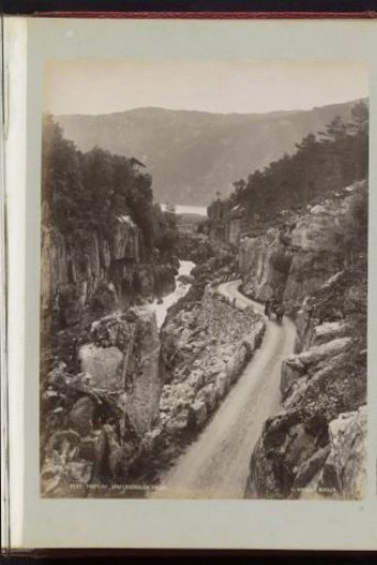 View of a road and a river through the Brattland Valley in Norway
