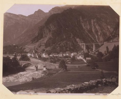 View of the Gotthard Railway at Amsteg with mountains and dwellings