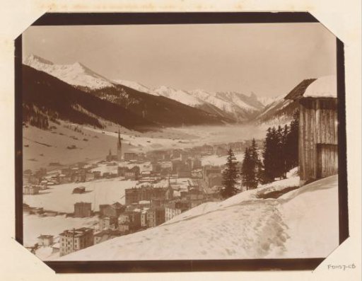 View of a snow-covered Davos with mountains in the background