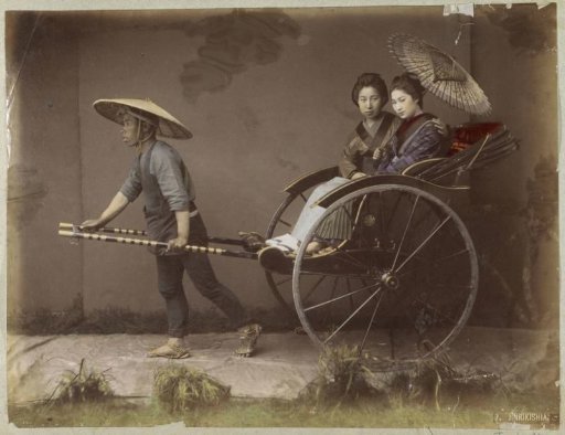 Portrait of a rickshaw puller with two female passengers