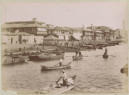 View of a quay at Port Said with rowing boats in the foreground