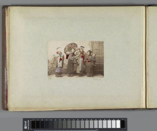 Group portrait of four Japanese girls with babies on their backs